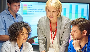 a health care risk professional working with a doctor, nurse and other members of a care team to address a problem