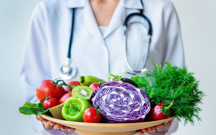 Doctor holding a bowl of fresh vegetables