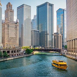 Chicago skyline and water taxi on river