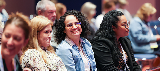 conference attendees sitting and smiling