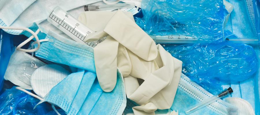 Gloves, masks, and other personal protective equipment sit in a pile.