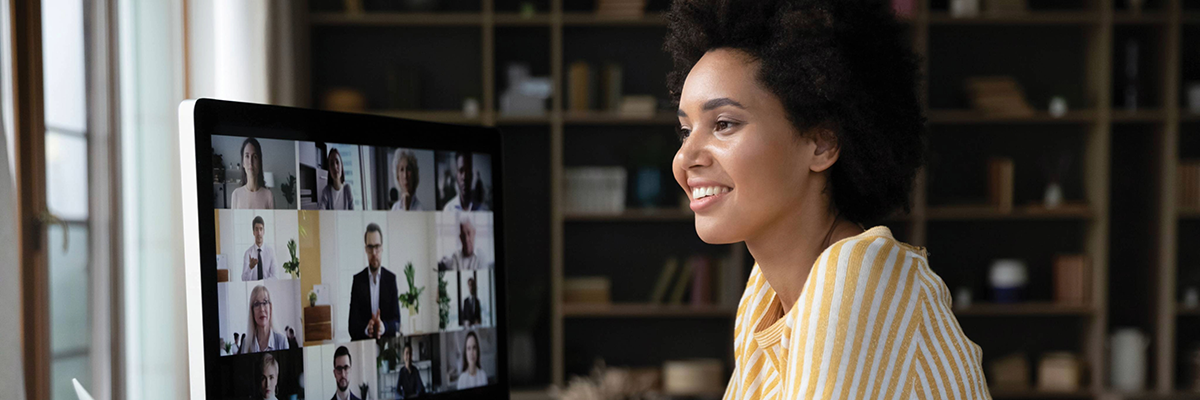 Woman at a desktop computer in a webinar with others