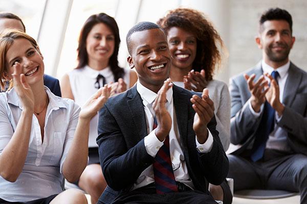 People clapping and smiling